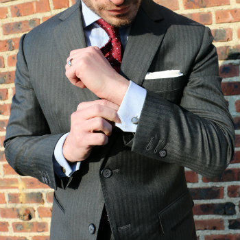 Man adjusting sleeve of power suit